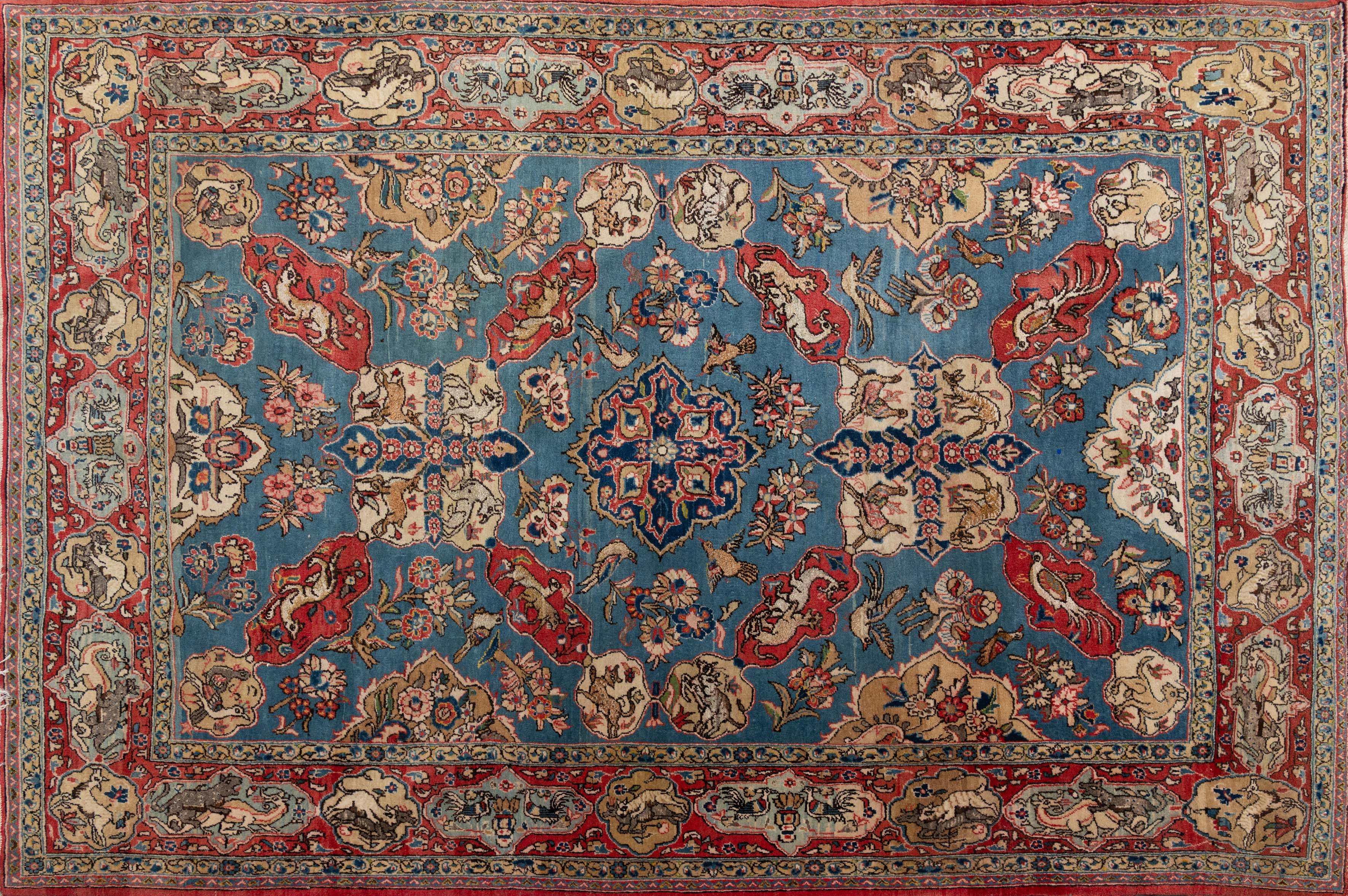 Alfombra persa en lana y seda. Campo color turquesa. Decorada con motivos vegetales y...