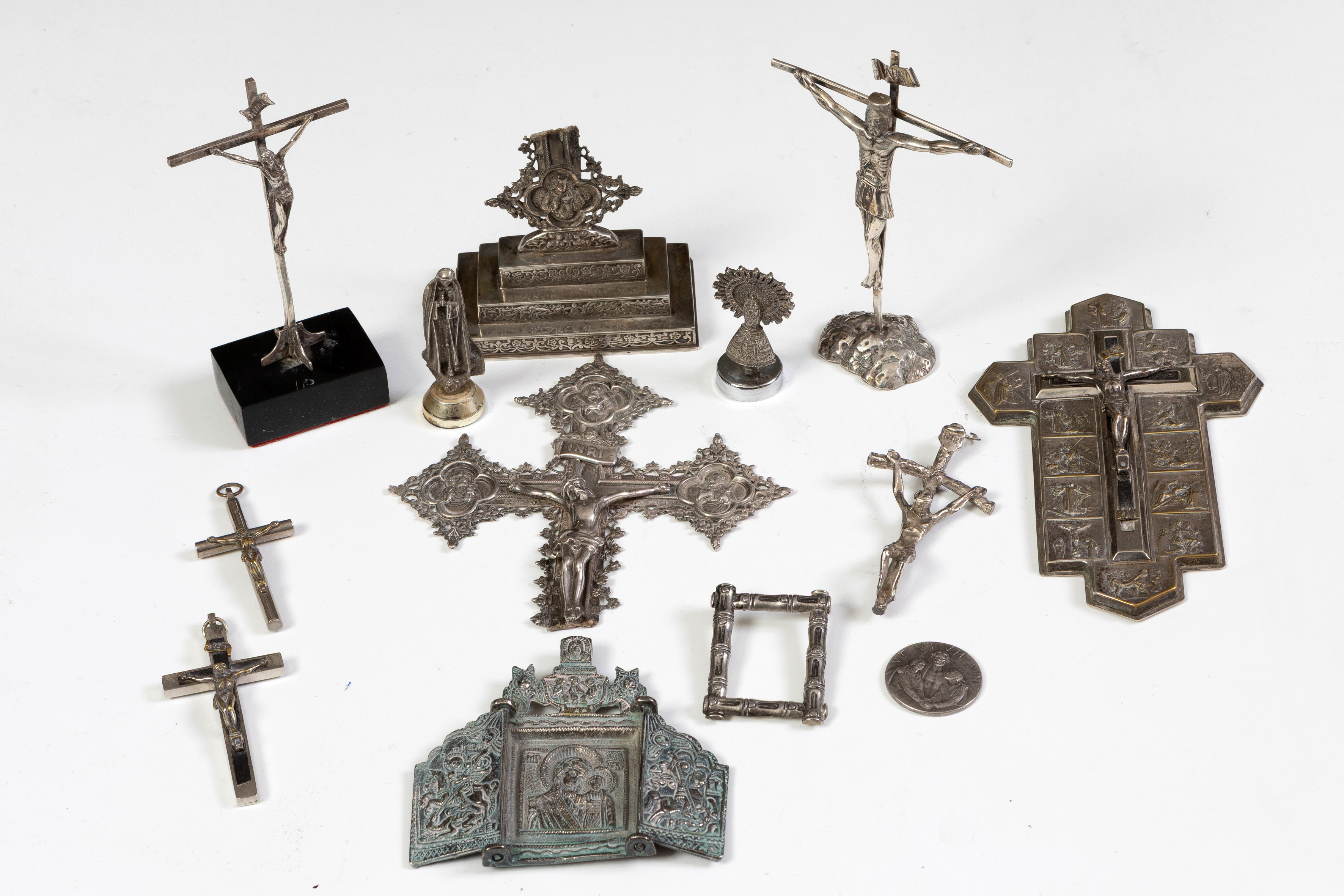 Lote en plata española punzonada compuesto por: 
3 cruces de escritorio, 1 Virgen del Pilar, 1...