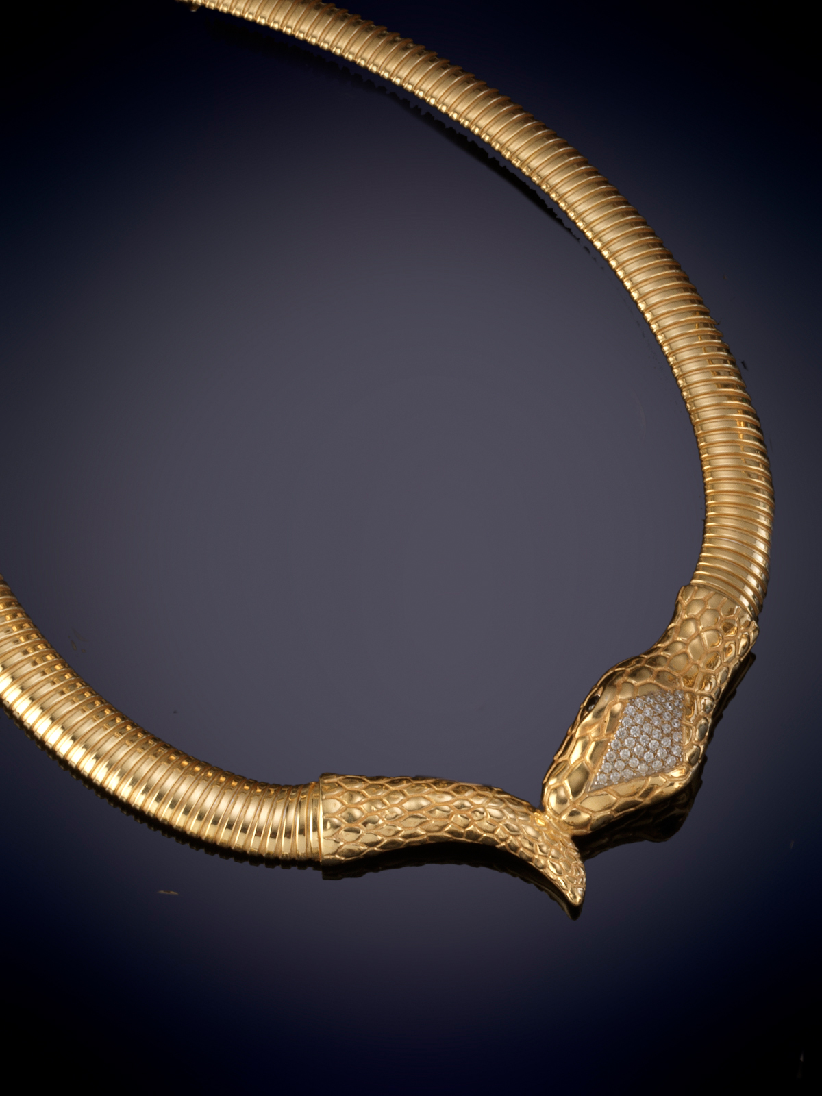 GARGANTILLA TUBOGAS CON CABEZA Y COLA DE SERPIENTE. Montura en plata con baño de oro amarillo de...