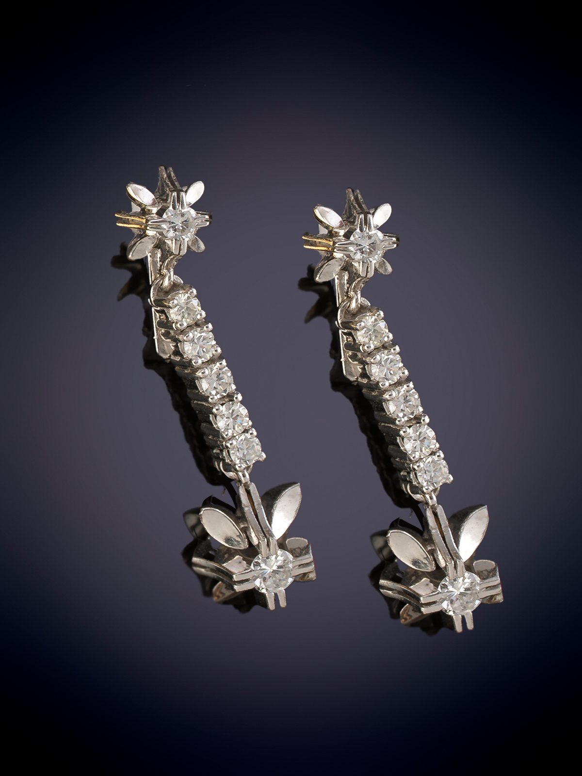 PENDIENTES LARGOS CON RIVIERE DE BRILLANTES REMATADOS EN FLOR.