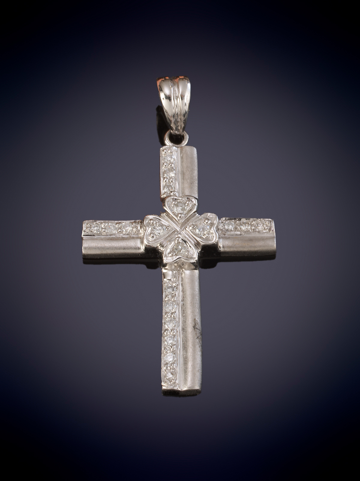 CRUZ DE ORO MATE Y BRILLANTES. Montura en oro blanco de 18k.