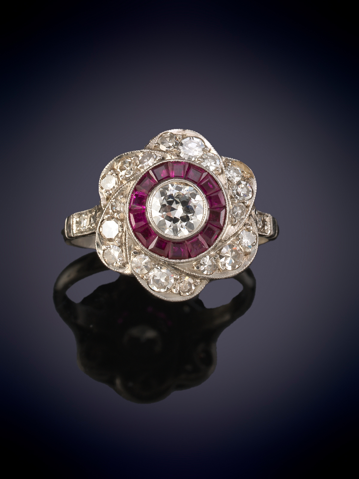 SORTIJA CON ROSETÓN EN FORMA DE FLOR DE BRILLANTES Y RUBÍES. PESO CENTRO DE BRILLANTES 0.38CT...