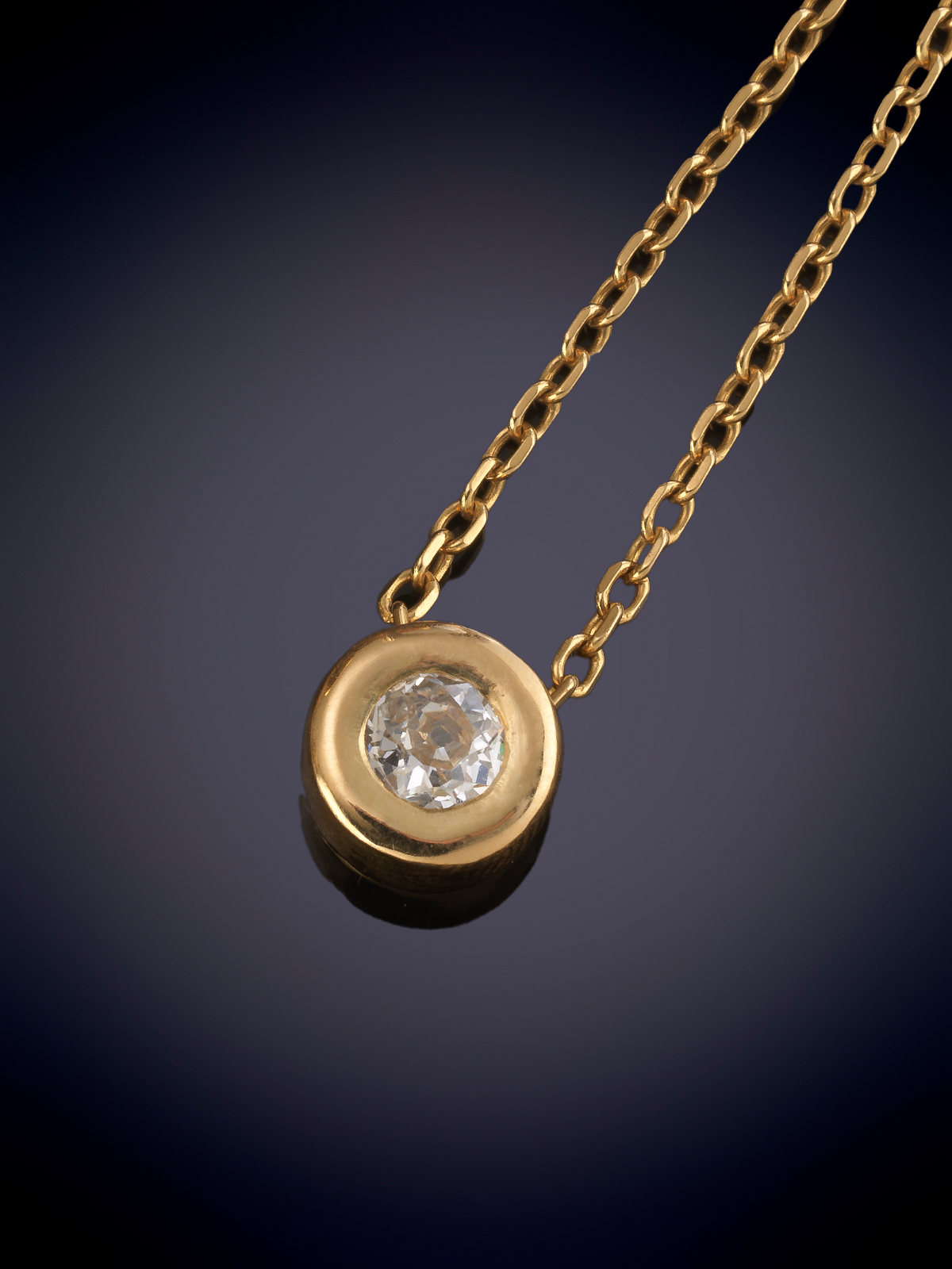 COLGANTE CON BRILLANTE EN CHATÓN CON UN PESO APROX. DE 0,60 CTS. CON CADENA DE ORO AMARILLO DE 18K.