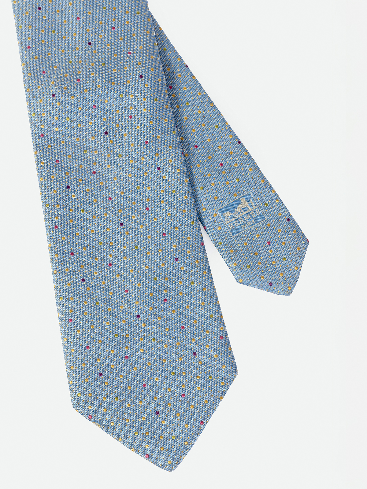HERMÉS. CORBATA EN COLOR AZUL CLARITO CON DETALLE DE MOTAS DE COLORES.