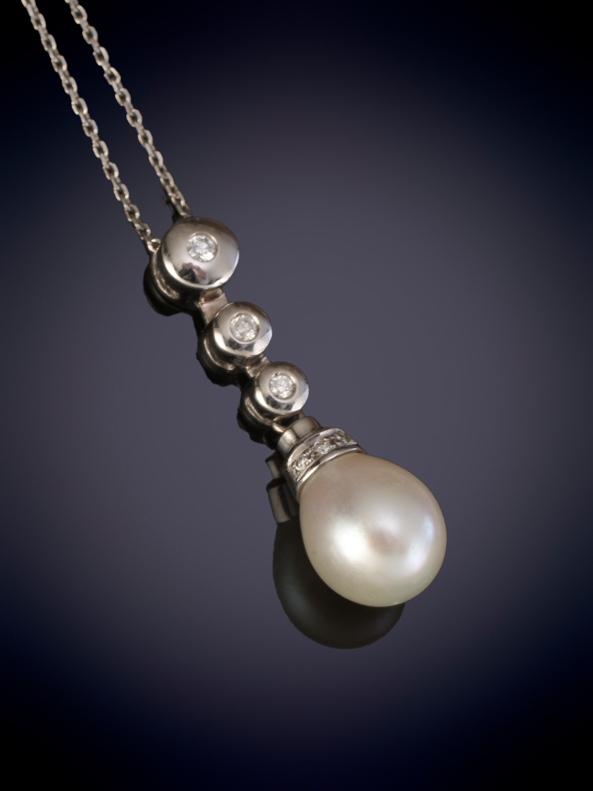 COLGANTE CON PERLA DE BELLO ORIENTE Y CASQUILLA CON HILERA DE BRILLANTES, CON CADENA DE ORO BLANCO...